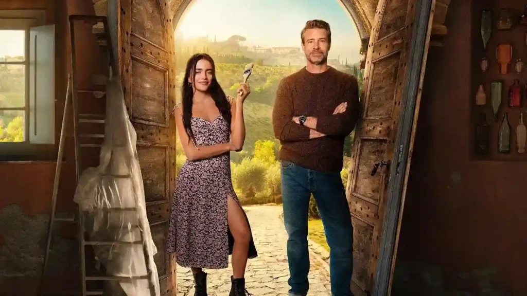 Couple standing in rustic stone doorway with wine glasses in Tuscan countryside landscape