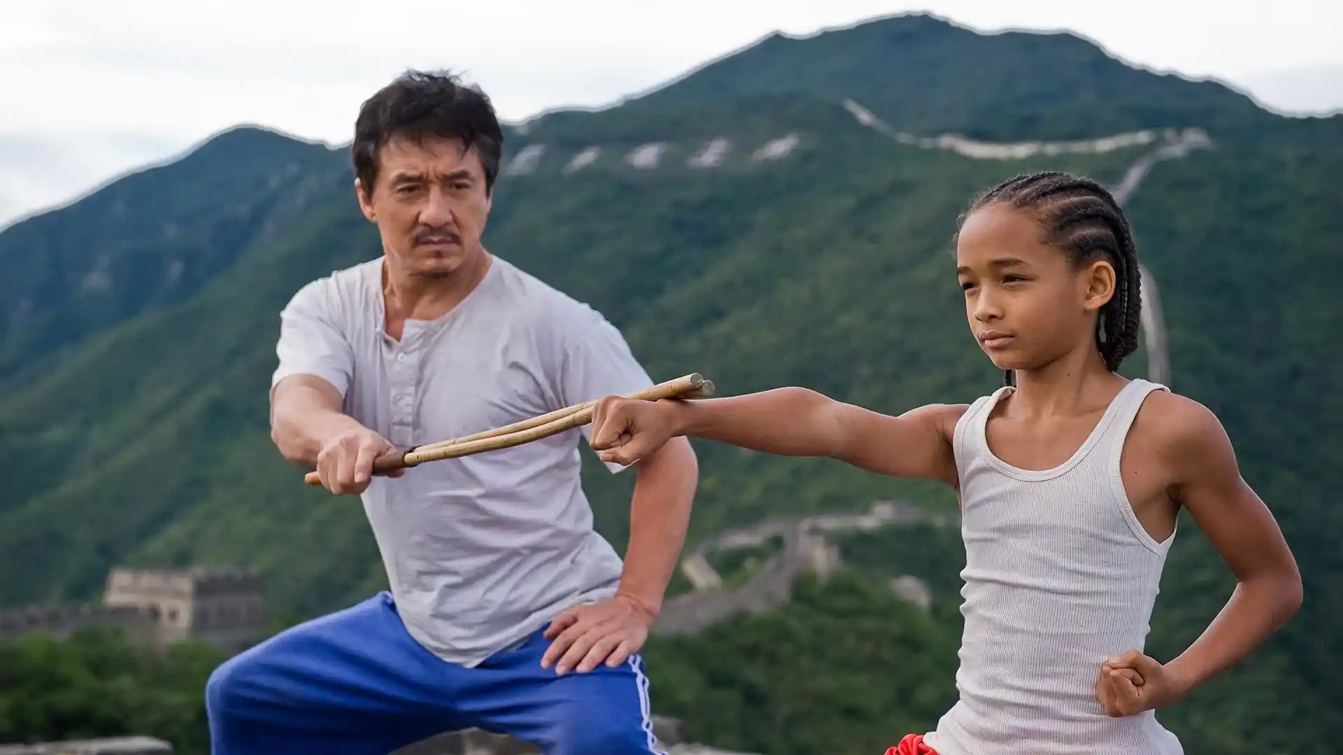 Jackie Chan mentors Jaden Smith in the 2010 remake of The Karate Kid (Credits: TMDB)